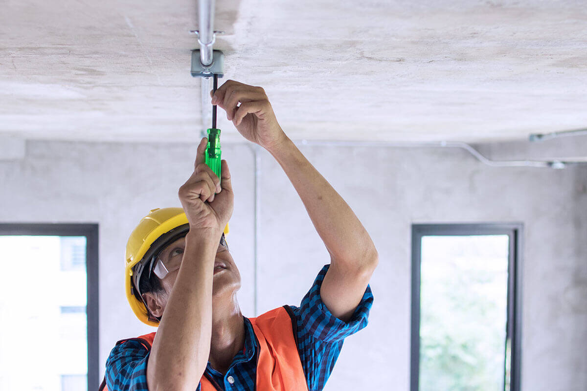 electrician working on ceiling light installation