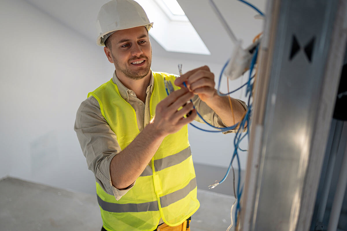 electrician fixing electrical cables with pliers