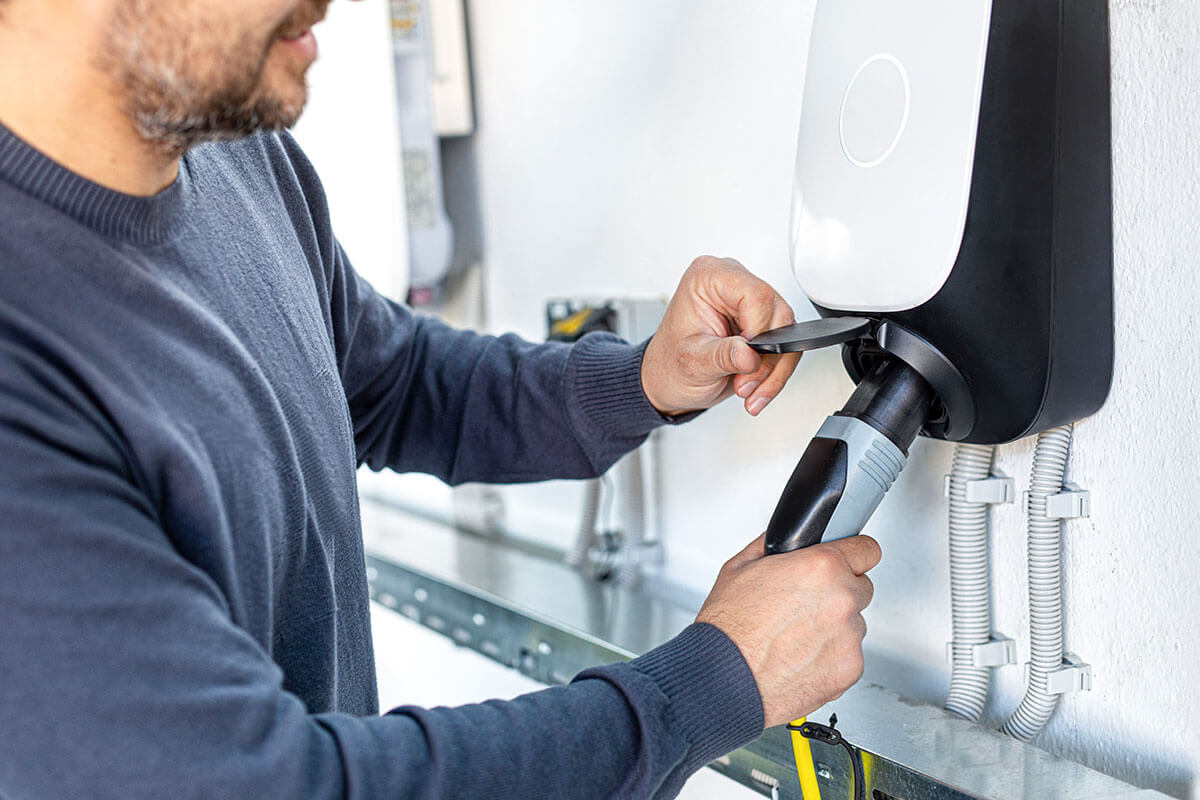 man using electric vehicle charging station