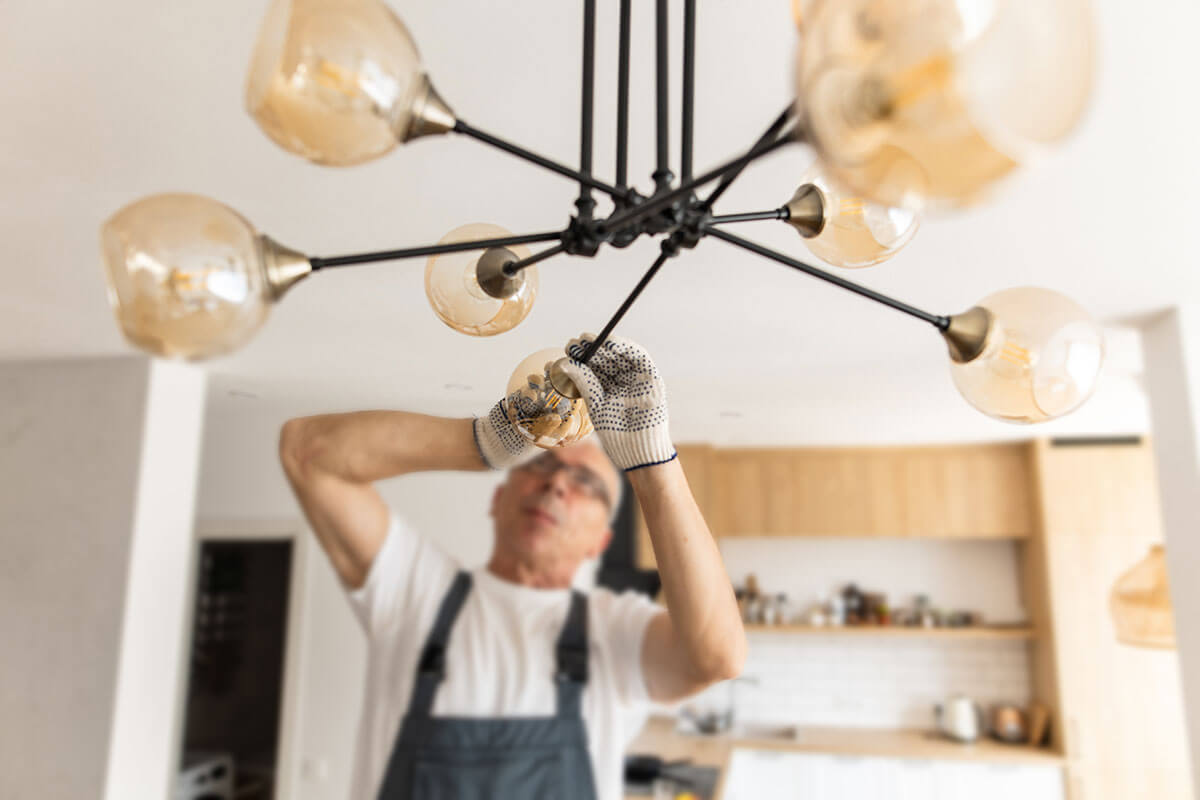 electrician installing cool light fixture in home