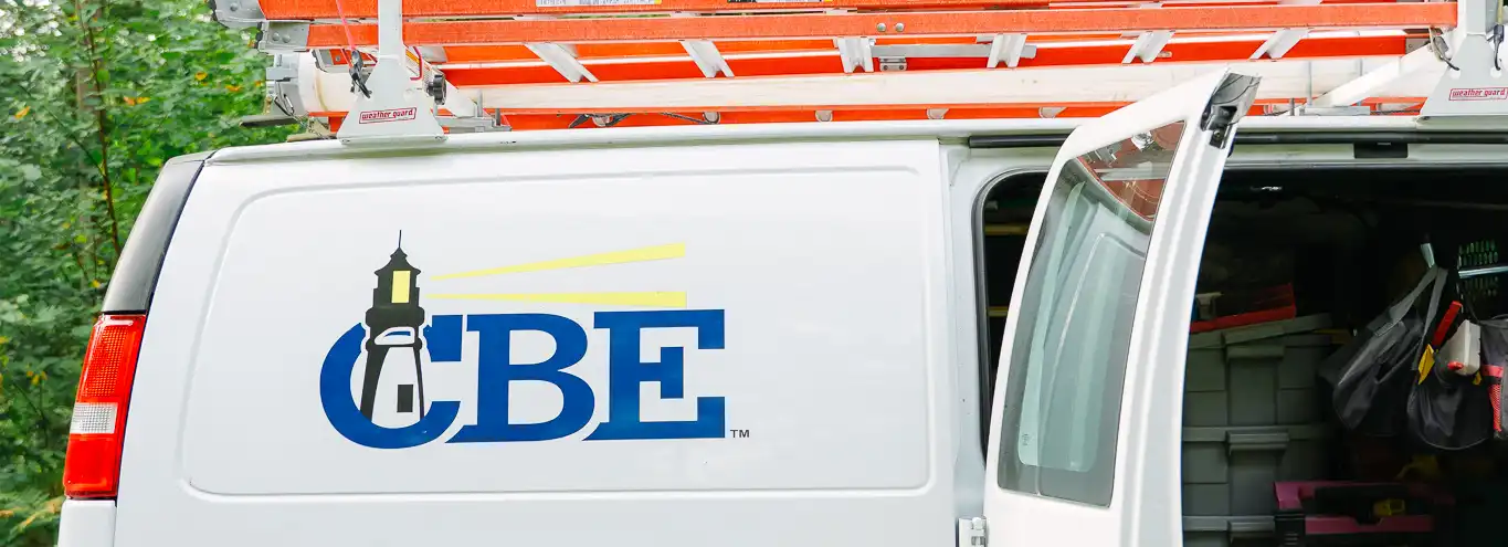 CBE van with doors open near trees